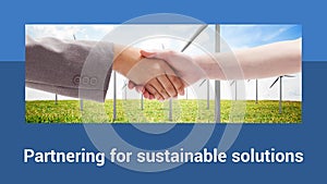 Partnering for sustainable solutions text with diverse female handshake and wind turbines in field