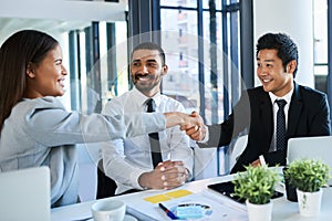 Partnering up to achieve success. Cropped shot of corporate businesspeople shaking hands in the workplace.