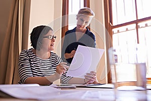 Partners in business. A cropped shot of two women working together in a home office.