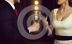 Partnership. clink glasses with white wine of couple at meeting