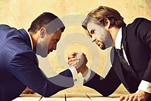 Partnership and teamwork, arm wrestling of businessman and compete man