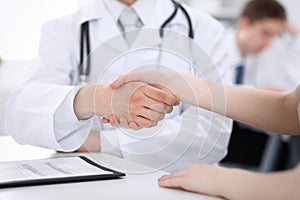 Partnership, trust og doctor and patient, medical ethics concept. Handshake in medicine