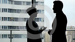 Partnership: woman and man silhouette discussing