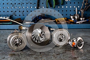 Parts of aluminum turbine close up. the new turbine for the diesel engine on a car workshop background