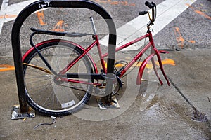 Parts of a Bicycle locked to a bike rack downtown Cleveland, Ohio, USA