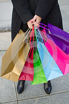 Parts of body of young woman with gift bags