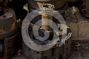 Parts of old engine parts on the ground.