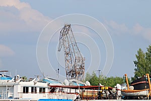 Parts of passenger ships and carnes for loading on river photo