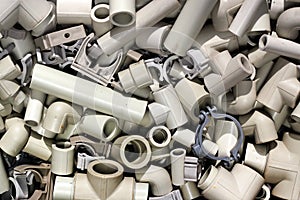 Parts of plastic piping and fitting as plumbing background