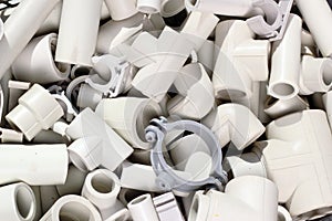 Parts of plastic piping and fitting as plumbing background