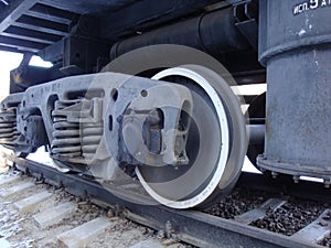 Parts of a railroad dump truck. Wheels, springs, oil pipe. Black with white stroke