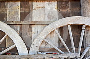 Parts of on wagon wheels on wooden wall