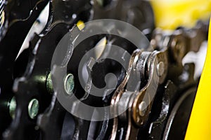 Parts of yellow bicycle on a studio white background. Close up details