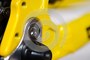 Parts of yellow bicycle on a studio white background. Close up details