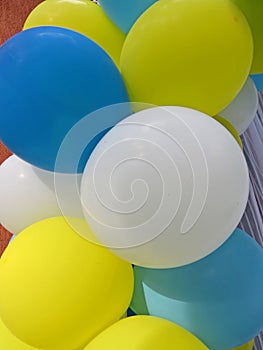 Party balloons in blue, white and yellow. Celebrating a birthday or wedding.