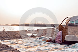 A party on the beach at sunset with wine. Romantic evening in the summer by the sea. Picnic. copy space