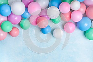 Party or birthday banner with colorful balloons on blue background top view. Flat lay style