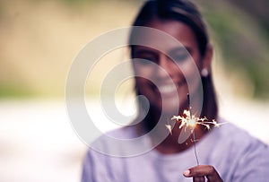 Party, birthday and woman with sparkle in hand for Christmas, festival celebration and new years. Light, fireworks and