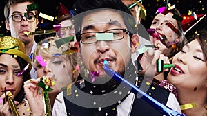 Party, blower and group in celebration with confetti and happiness at event in slow motion. Happy, surprise and portrait