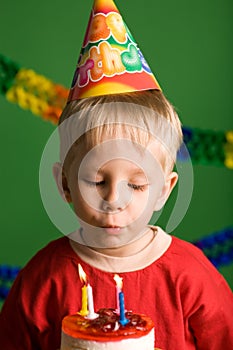 Party boy blowing birthday candles