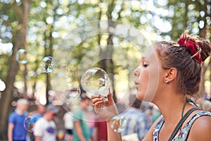 Party, bubbles and music with woman at festival in forest for celebration, summer and performance. Carnival, culture and