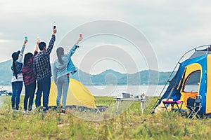 Party Camping.  Group asian family and friends travel enjoy party and roasted sausages relax in vacations.