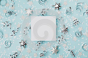 Party carnival christmas mockup decorated confett and silver star on turquoise background top view. Flat lay. Holiday invitation.