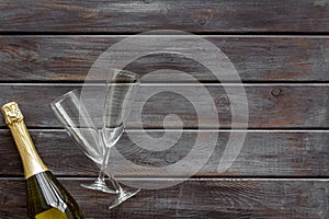 Party with champagne bottle and glasses on wooden background top view space for text