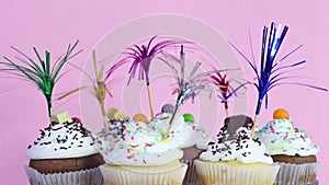Party decorated cup cakes with white cream and crumbs