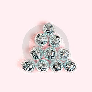 Party Disco balls on pastel pink background.