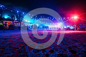 party and drink at the summer beach night. blue and red colors. neon and flashlights