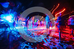 party and drink at the summer beach night. blue and red colors. neon and flashlights