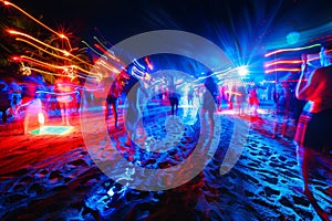 party and drink at the summer beach night. blue and red colors. neon and flashlights