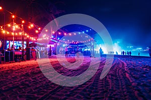 party and drink at the summer beach night. blue and reds colors. neon and flashlights