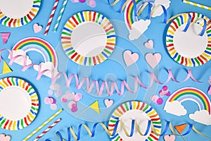 Party flat lay with colorful plates, rainbow napkins and drinking straws