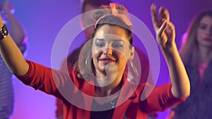 Party flythrough shot of group of people and friends dancing to cool music with disco . Smoke background. Slow motion