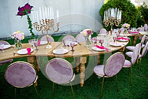 Party in the garden. Flowers, glasses and Balloons Arrangement. Festive table setting. Party with a special theme.