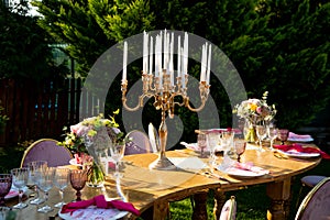 Party in the garden. Flowers, glasses and Balloons Arrangement. Festive table setting. Party with a special theme.