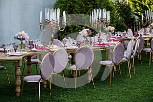 Party in the garden. Flowers, glasses and Balloons Arrangement. Festive table setting. Party with a special theme.