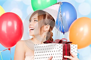 Party girl with balloons and gift box