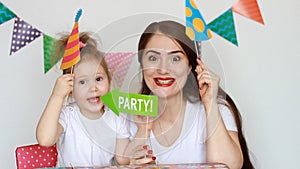 Party. Happy birthday. Mother and daughter have fun, smiling and laughing and different decorations to celebrate the