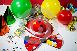 Party hat with bow, balloons and streamers