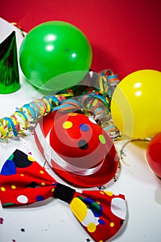 Party hat with bow, balloons and streamers