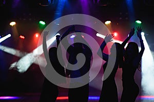 party, holidays, celebration, nightlife and people concept - group of happy friends dancing in a night club