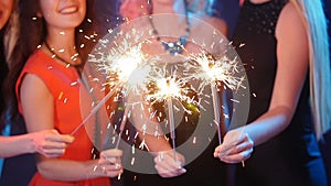 Party, holidays, nightlife and happy new year concept - Group of happy women having fun with sparklers
