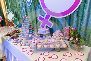 Party with macaroon tower and cakes photo