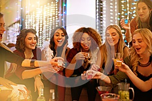 Party, nightclub and women with alcohol shots for birthday celebration, ladies night and social event. Cheers, toast and