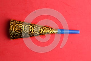 Party noisemaker isolated on a red background