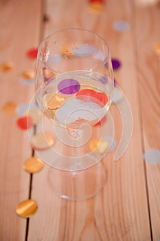 Party over background empty wine glass confetti