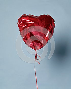 Party is over deflated red heart balloon object for birthday party or love valentines day photo